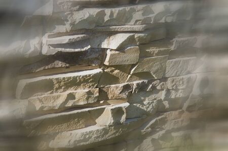 Texture, background, pattern. Natural stone lined wall. Hard rock chunks or solid mass, as well as a...