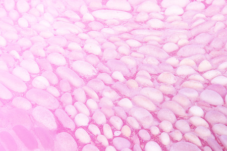 texture, background. The pavement of granite stone. Paved roadway street. any paved area or surface. Old cobblestone road pavement texture, grass between stonesの写真素材