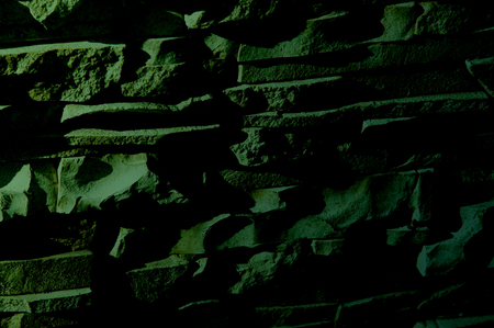 Texture, background, pattern. Natural stone lined wall. Hard rock chunks or solid mass, as well as a...