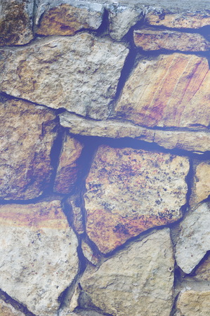 Texture, background. Fence lined with wild stone, granite, sandstoneの写真素材