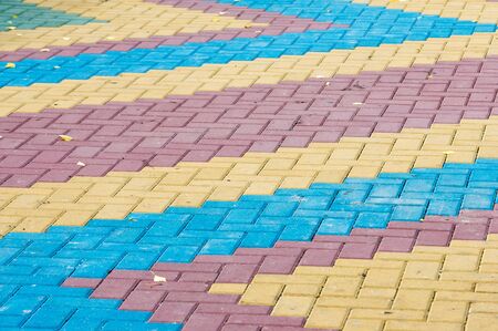 Texture, background. Sidewalk blocks of color, autumn leaves lie on the pavementの写真素材