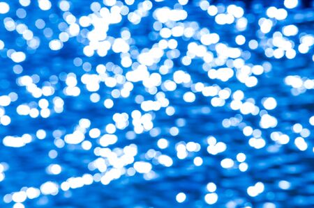 Texture, pattern, background. blurred image Gaussian. The reflection of the sun on the water. Sunlight on Waterの写真素材