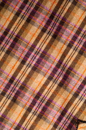 cutting a woman's skirt. Wool Scottish cage. Texture
