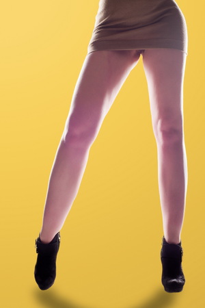 Feet girl. feet, trotters, pins, landing gear, locomotives, trilbies. Sexy girl long legs. Photographed backlit.の写真素材