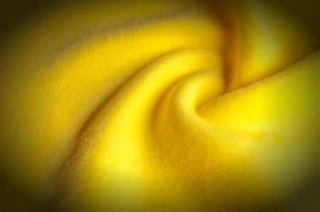 Texture background pattern. Woolen yellow fabric, cloth for a blanket, outer clothing.  Closeup horizontal fragmentの写真素材