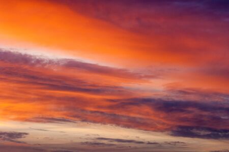 Texture, background, pattern. Evening, morning sky, bright colors on the clouds.Colorful sky and sunrise. Natural landscape. Early morning sky with colors from deep blue to orange.の写真素材