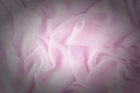 Texture, background, pattern. Silk fabric pale pink, abstract folds
