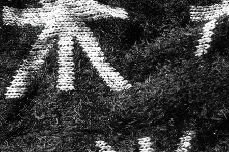 Texture, background, pattern. Warm female winter woolen black sweater. On a black background, white starsの写真素材