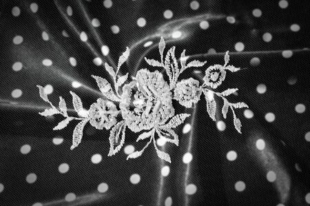 Texture, background, pattern. Lacy white fabric. Flowers made of lace fabric. Pink background of silk fabric. greeting card. Wallpaper for your desktop. Screensaver backdrop for designerの写真素材