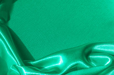 Texture, fabric, background. Abstract background of luxurious fabric or liquid waves or wavy grunge crease silk satin texture of velvet material or luxurious Christmas . greenの写真素材