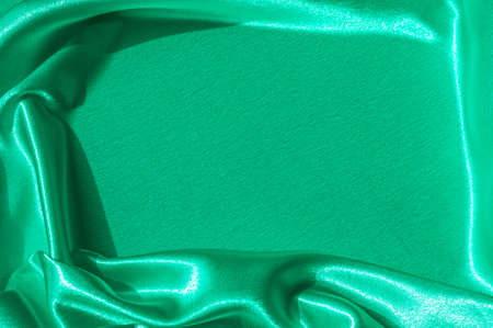 Texture, fabric, background. Abstract background of luxurious fabric or liquid waves or wavy grunge crease silk satin texture of velvet material or luxurious Christmas . greenの写真素材