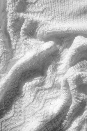 Texture, background, pattern. Women's woolen white winter sweater