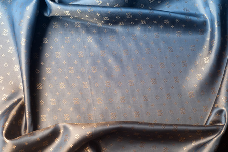 Texture background pattern. Brown silk fabric. Abstract background of luxury fabrics or liquid waves...