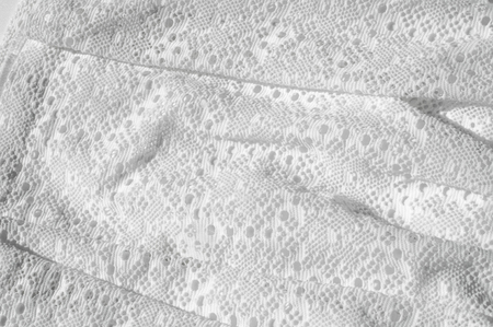 Texture, background, pattern. White girl's skirt, with a broken pattern in the form of circles. White lace cottonの写真素材