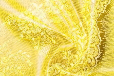 Background texture, pattern. Lace is yellow fabric.の写真素材