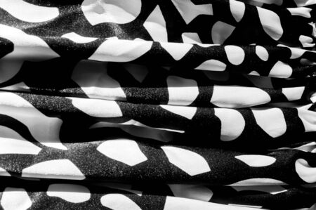 Texture, background, pattern. Women's silk dress dress. Silk fabric black and white in an abstract pattern, black white geometric shapesの写真素材