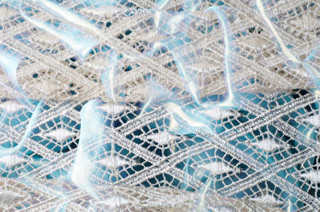 Texture background pattern. Lacy white fabric. Hand lace on white background. White guipure,...
