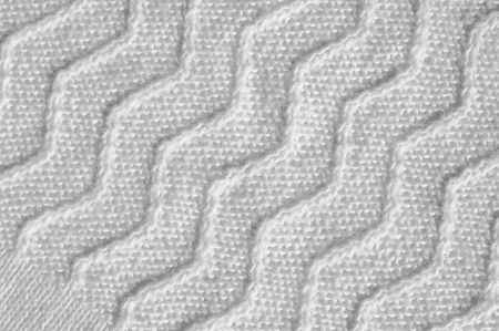 Texture, background, pattern. Women's woolen white winter sweater