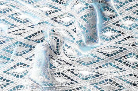 Texture background pattern. Lacy white fabric. Hand lace on white background. White guipure,...