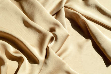 Texture, background, pattern. Women's shawl Colors. Goldenrod. Lemon cream. The Navajo is white. The old gold. silk fabric.の写真素材