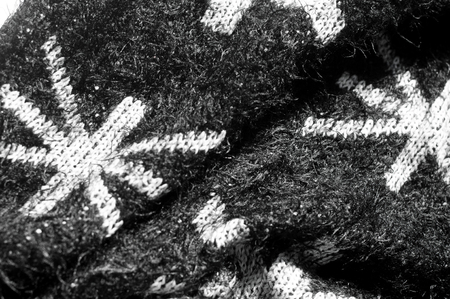 Texture, background, pattern. Warm female winter woolen black sweater. On a black background, white starsの写真素材
