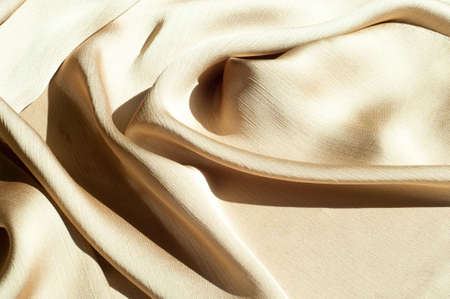 Texture, background, pattern. Women's shawl Colors. Goldenrod. Lemon cream. The Navajo is white. The old gold. silk fabric.の写真素材