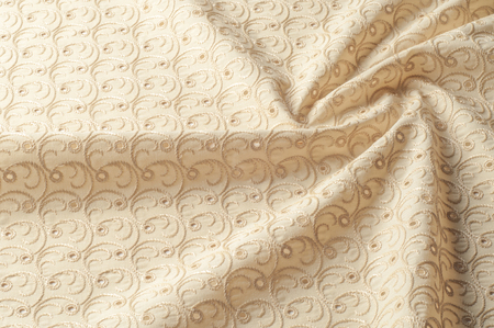 Texture background of fabric. Beige fabric with punctured circles. Beige background. Abstract...