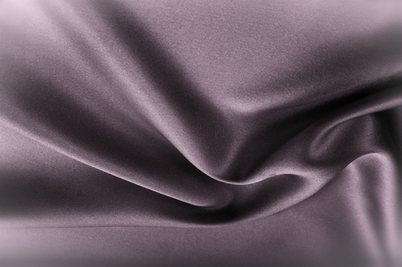 Texture fabric background. Black white silk fabric. Fragment of an abstract background of luxurious fabrics or liquid waves or wavy folds of a grunge silk texture of a satin velvet materialの写真素材