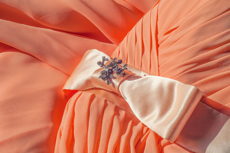 Texture, background, pattern. A dress of light orange color, a silk ball gown. Fabric coral silkの写真素材