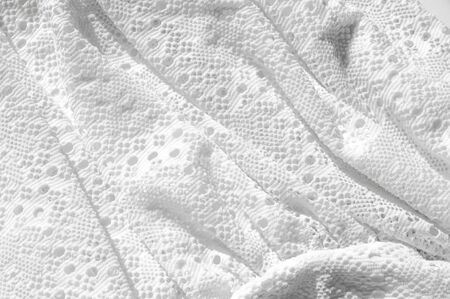 Texture, background, pattern. White girl's skirt, with a broken pattern in the form of circles. White lace cottonの写真素材