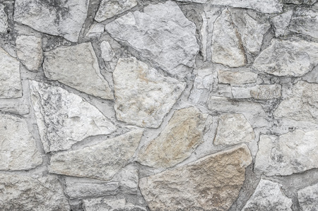 Texture, background, pattern. Old granite stones. An old stone wall. Texture of a stone wall. Brick wall from an old gray stone and sandstone texture background.の写真素材