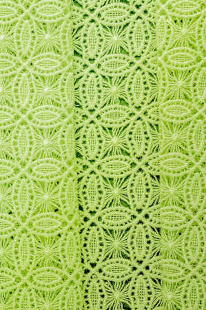 Image texture background, decorative lace with pattern.  green vintage lace background. Green lace on white spandex background, macro view. Ornamental round laceの写真素材