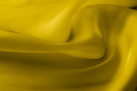 Texture, background, pattern. Yellow transparent silk fabric. Sunshine Yellow Silk Charmeuse Satin,の写真素材
