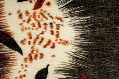 Texture, background, pattern. Women's woolen scarf. White, red, brown, black. Abstract pattern.