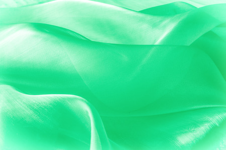Texture, background, pattern. Green silk fabric for draping. Abstract Fabric, Artistic Waving Cloth Fractal Pattern.の写真素材
