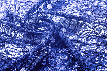 Texture, background, pattern. Cloth of blue lace. Background of fabric from lace stylized roses....