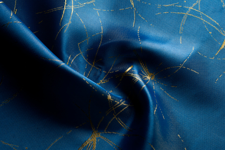 Texture, background, pattern. Blue silk fabric with painted sparks of fire. PURE SILK CREPE BACKED SATIN CHARMEUSE FABRICの写真素材