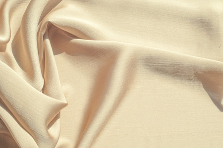 Texture, background, pattern. Women's shawl Colors. Goldenrod. Lemon cream. The Navajo is white. The old gold. silk fabric.の写真素材