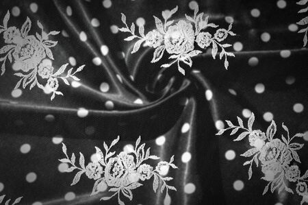 Texture, background, pattern. Lacy white fabric. Flowers made of lace fabric. Pink background of silk fabric. greeting card. Wallpaper for your desktop. Screensaver backdrop for designerの写真素材