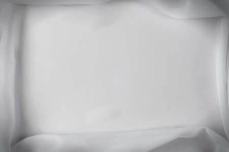 Texture, background, pattern. Silk fabric of white color, abstract folds.Smooth elegant white silk or satin textureの写真素材