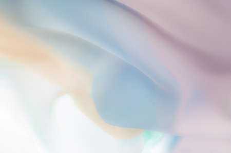 Blurry, not sharp sharpness Texture, background, pattern. Silk fabric is transparent, yellow-pink green in blue. Abstract soft chiffon texture background.の写真素材