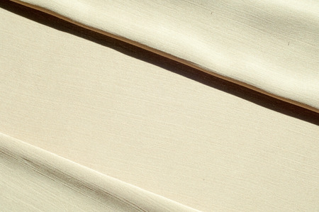 Texture, background, pattern. Women's shawl Colors. Goldenrod. Lemon cream. The Navajo is white. The old gold. silk fabric.の写真素材