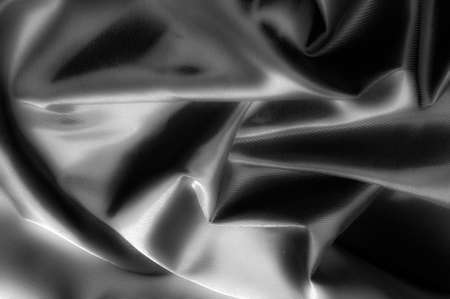 Texture, background, pattern. Black silk fabric.Pure Silk Charmeuse Crepe Backed Satin in BLACK fabric. Wide Stretch Silk Charmeuse Black By the Yardの写真素材