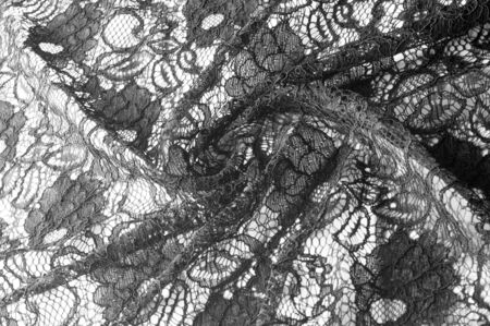 Texture, background, pattern. Fabric of black lace. Background of fabric from lace stylized roses. Abstract lace pattern with flowers. Wallpaper, underwear and jewelry. Your invitationsの写真素材