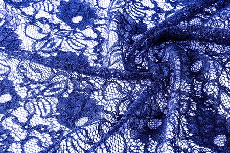 Texture, background, pattern. Cloth of blue lace. Background of fabric from lace stylized roses. Abstract lace pattern with flowers. Wallpaper, underwear and jewelry. Your invitationsの写真素材