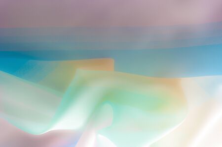Blurry, not sharp sharpness Texture, background, pattern. Silk fabric is transparent, yellow-pink green in blue. Abstract soft chiffon texture background.の写真素材