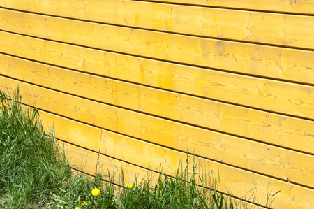 Texture, background, pattern. Good background. The boards are connected as a shield. A wooden wall with green grass. Wood texture, Natural wood background.の写真素材