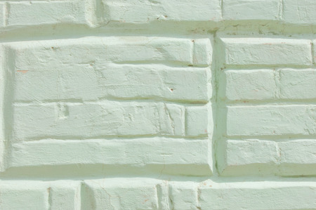 Texture, background, pattern. The brick is laid out decoratively. Brickwork, painted. Old brick wall with white and blue brick background. Ancient brick wallの写真素材