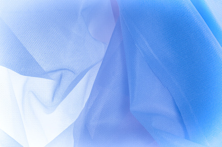 Texture, background, The texture of the silk fabric is blue. Silk fabric is transparent. Fabric or liquid wave illustration wavy creases of silk satin texture or velvet material or blue luxuriousの写真素材