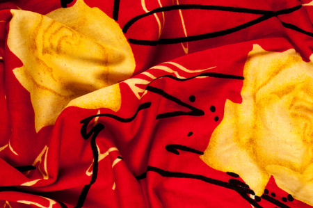 Background texture, pattern. Red silk fabric Yellow roses. Printed Chiffon Floral fabric Polyester Chiffon by the yard. Soft, translucent, light, fabric. Perfect for ball gown, wedding dress.の写真素材